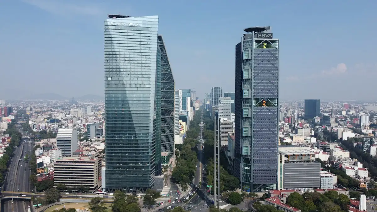 Glass skyscrapers along Paseo de la Reforma in Mexico City on a clear day.