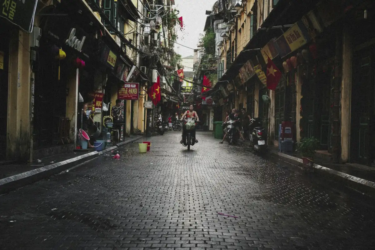 A motorbike rider on a cobbled street in Hanoi's Old Quarter.
